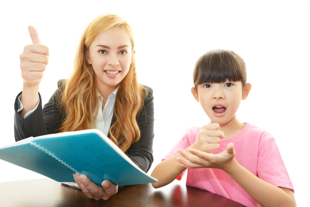 外国人英語教師が日本人女児に英語を教えている